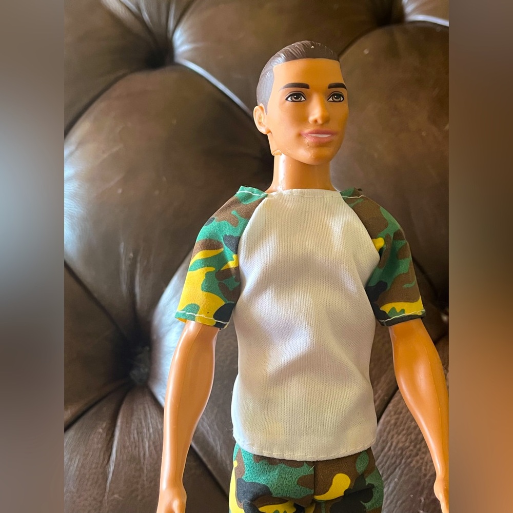 Ken doll with man bun. Latin man with hazel eyes. Comes with camo outfit.